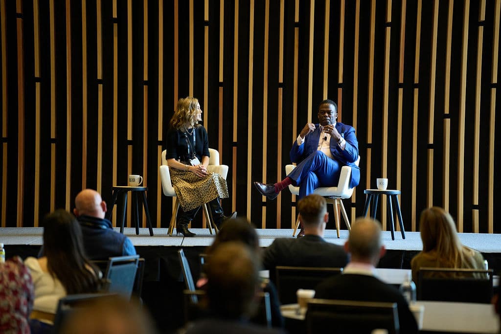 man and woman on stage at a conference