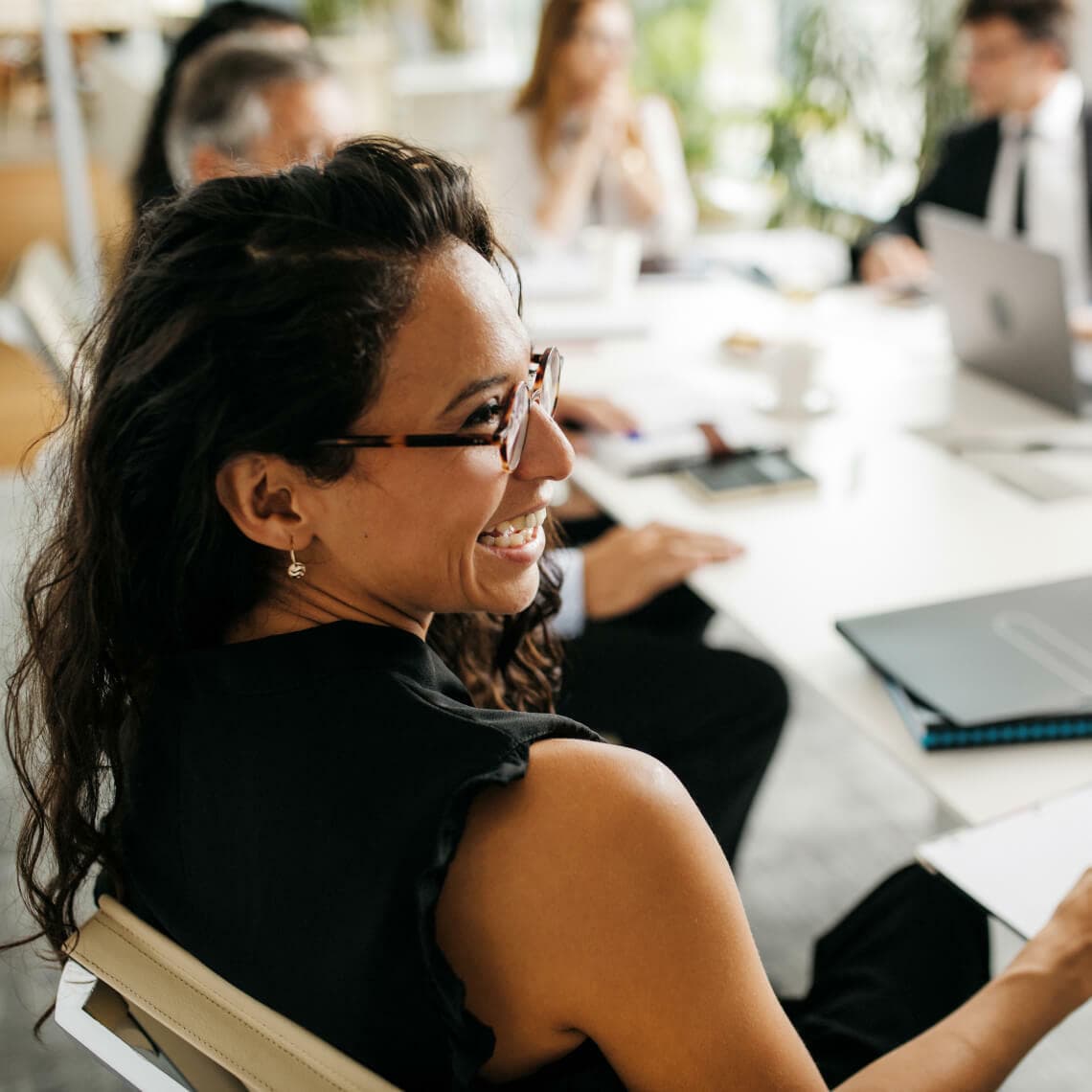 woman in glasses in office at table