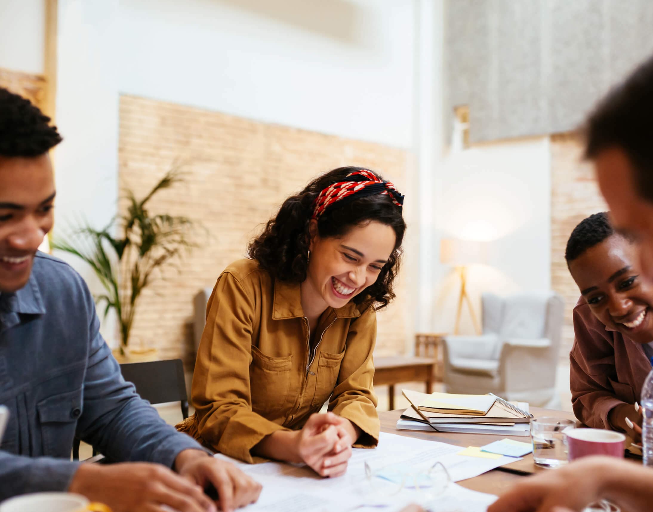 woman sitting at desk smiling with coworkers