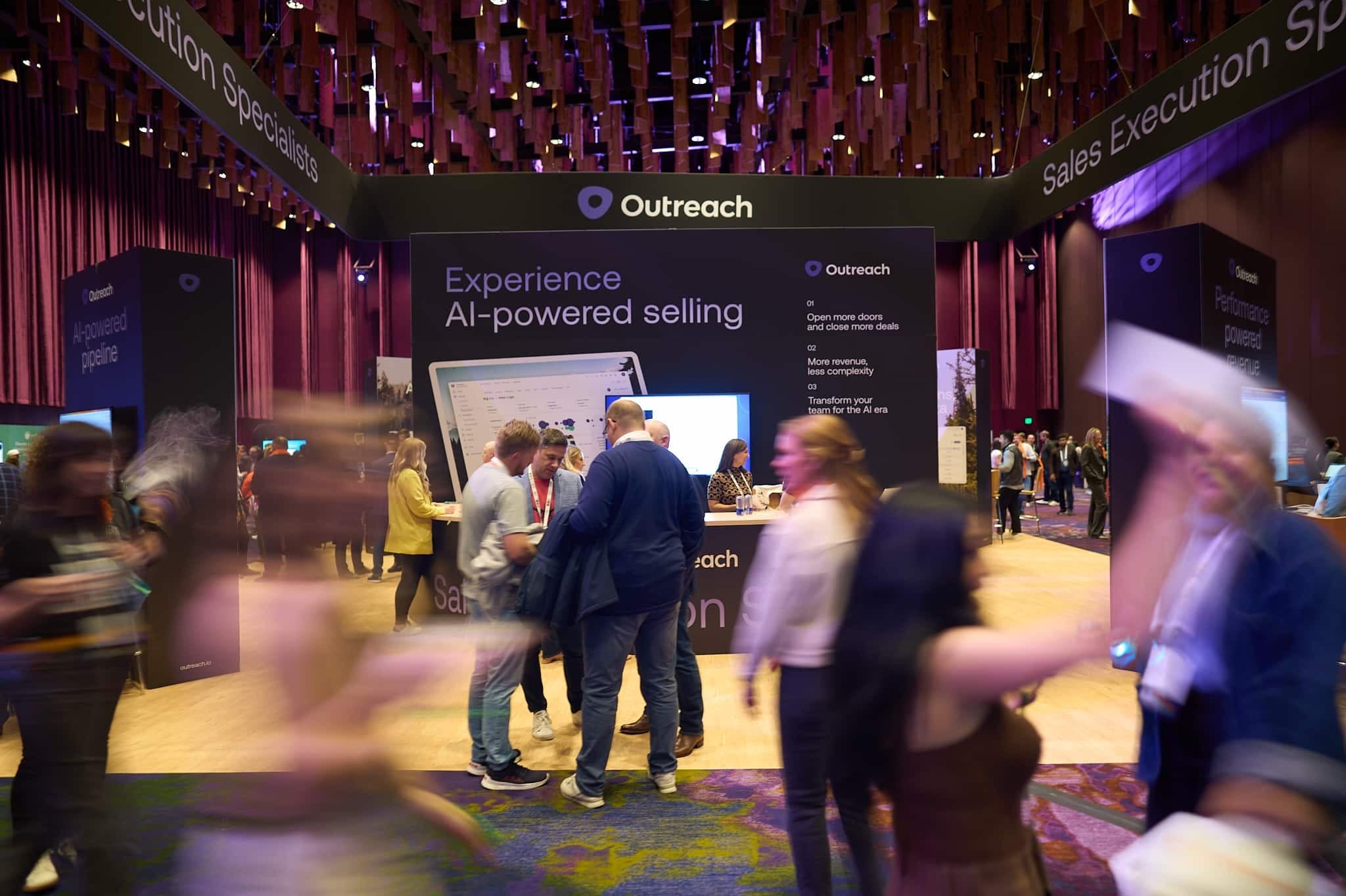 People visiting a booth at a conference tradeshow