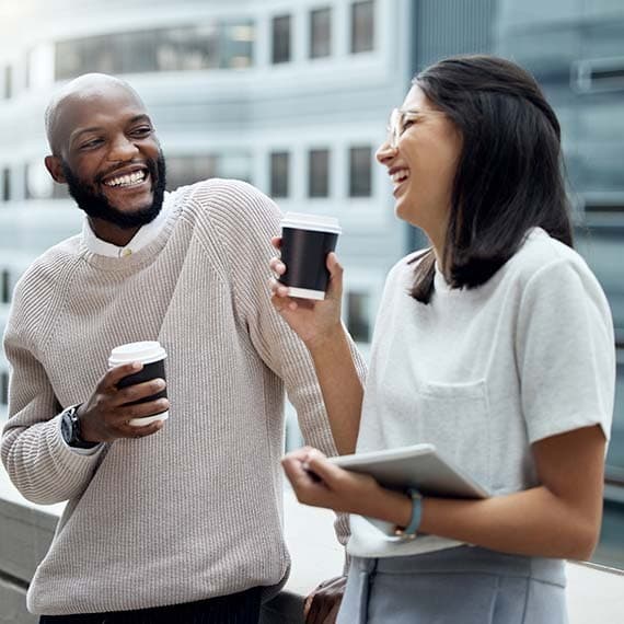 Two coworkers laughing together